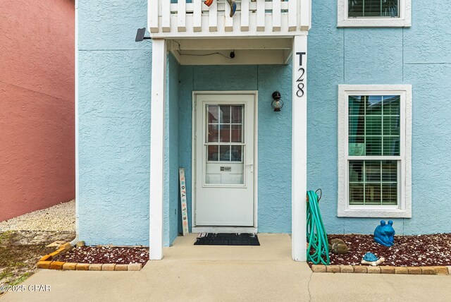 17214 Front Beach Rd Unit T28, Panama City Beach, FL 32413 - view of exterior entry with stucco siding