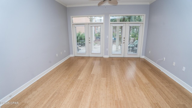 unfurnished room featuring crown molding, french doors, ceiling fan, and light wood-type flooring