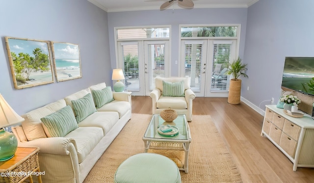 living room featuring french doors, ceiling fan, crown molding, and light hardwood / wood-style floors