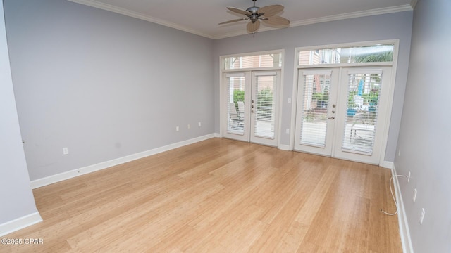 unfurnished room with ornamental molding, french doors, and light wood-type flooring