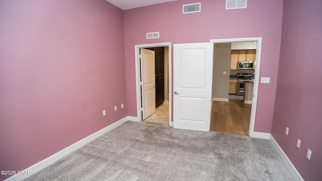 unfurnished bedroom with light carpet