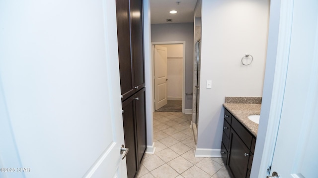 bathroom with vanity, an enclosed shower, and tile patterned flooring