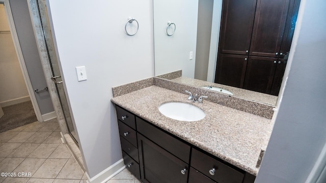 bathroom featuring vanity, an enclosed shower, and tile patterned flooring