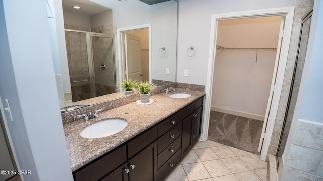 bathroom with vanity, tile patterned floors, and a shower with door