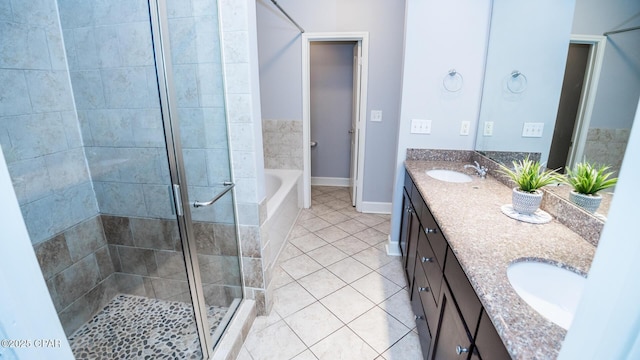 bathroom featuring tile patterned flooring, vanity, and shower with separate bathtub