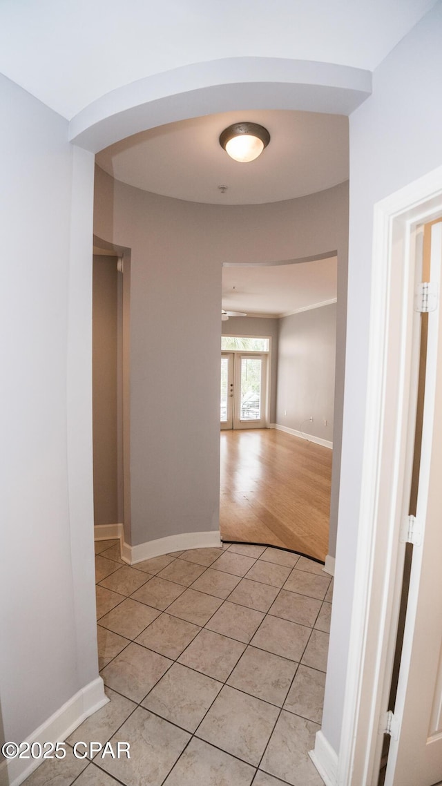 hall featuring light tile patterned flooring