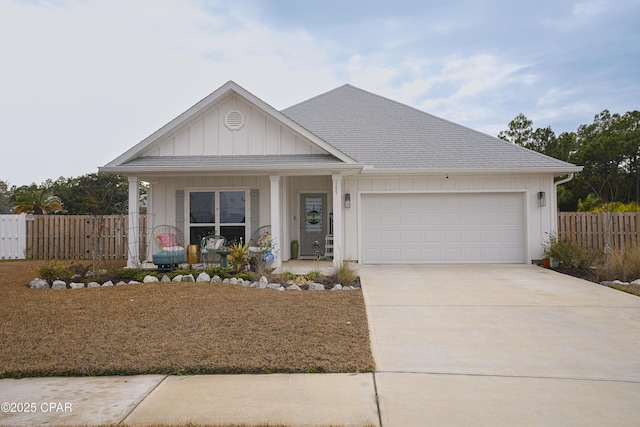 view of front facade featuring fence, driveway, a garage, and board and batten siding