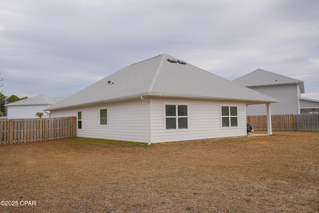 back of house featuring a lawn