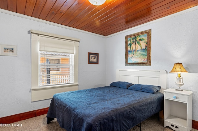 carpeted bedroom featuring a textured wall, wood ceiling, crown molding, and baseboards