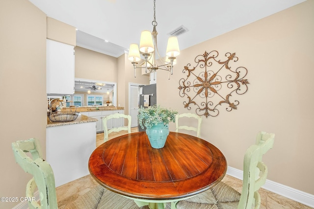 dining room with ceiling fan with notable chandelier and sink