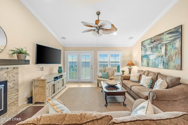 living room with a stone fireplace, hardwood / wood-style floors, lofted ceiling, ornamental molding, and ceiling fan