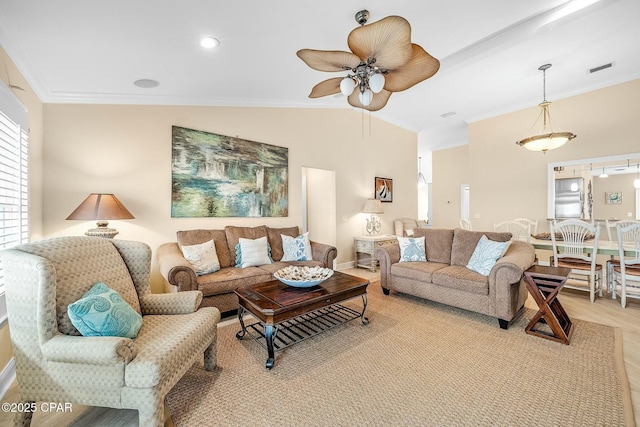 living room with ornamental molding, lofted ceiling, and ceiling fan