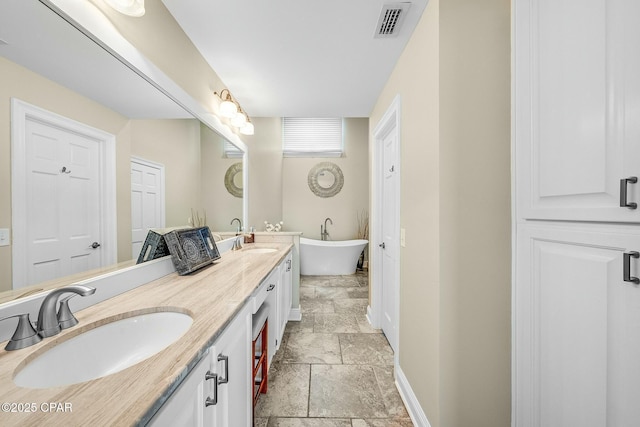 bathroom with vanity and a tub to relax in