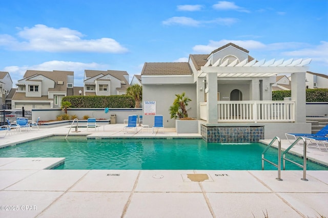 view of pool with a pergola, a patio area, and pool water feature