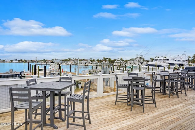 wooden deck featuring a boat dock and a water view