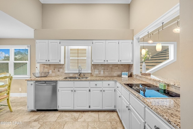 kitchen featuring white cabinetry, sink, pendant lighting, and stainless steel dishwasher