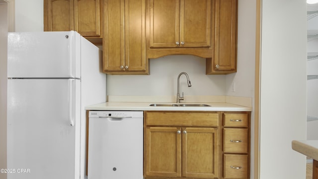 kitchen featuring white appliances and sink