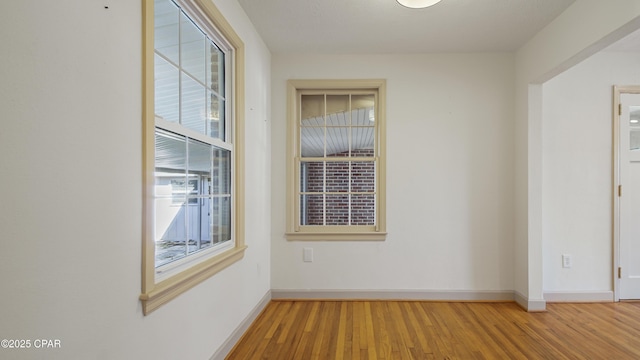 spare room with hardwood / wood-style flooring