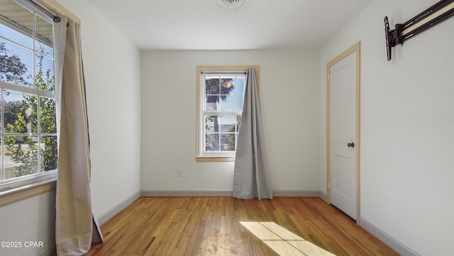 unfurnished room with light wood-type flooring