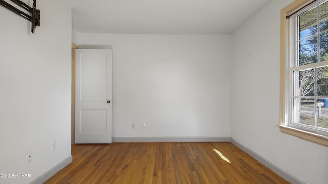 unfurnished room with dark hardwood / wood-style flooring