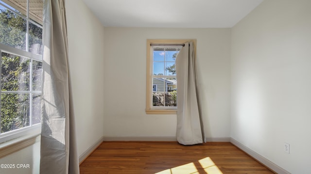 unfurnished room with wood-type flooring