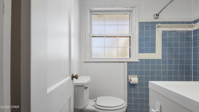 bathroom with a shower and toilet