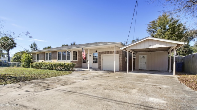 ranch-style house with a garage, a front yard, and a carport