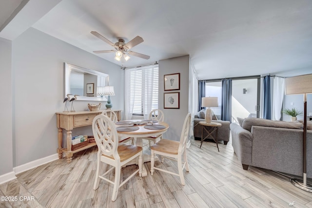 dining space with ceiling fan and light wood-type flooring