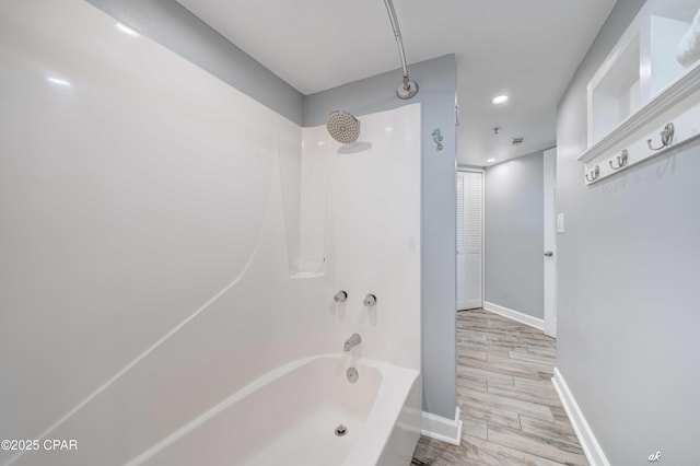 bathroom with hardwood / wood-style floors and shower / bathtub combination