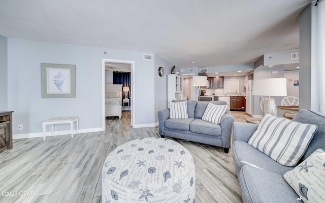 9850 S Thomas Dr Unit 806W, Panama City Beach, FL 32408 - living room featuring light wood finished floors and baseboards