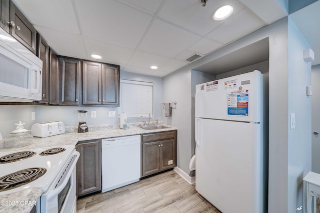 kitchen featuring white appliances, sink, a paneled ceiling, and dark brown cabinets