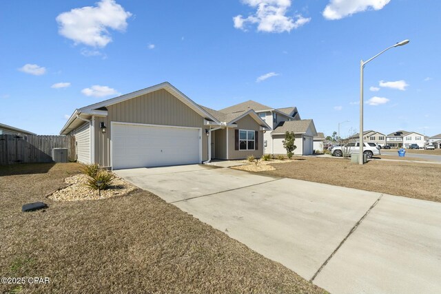 ranch-style house with a garage and central AC unit