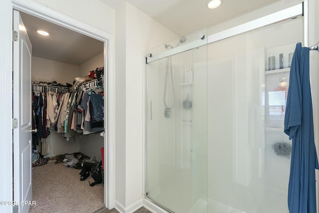 bathroom featuring a shower with shower door