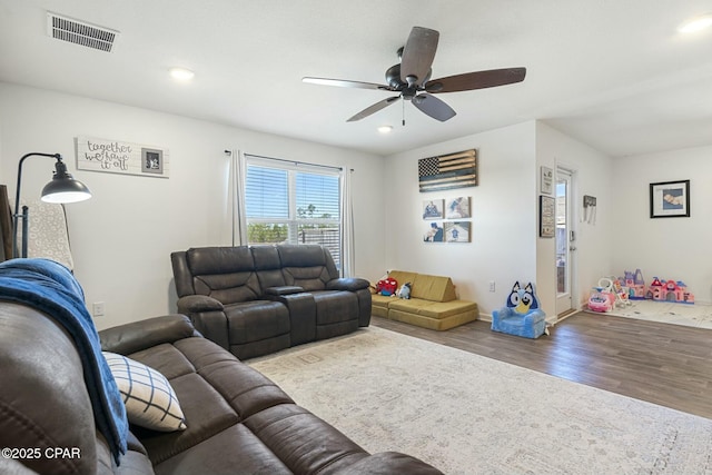 living room featuring hardwood / wood-style flooring and ceiling fan