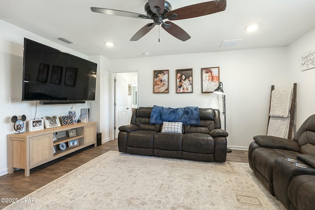 living room featuring dark hardwood / wood-style floors and ceiling fan