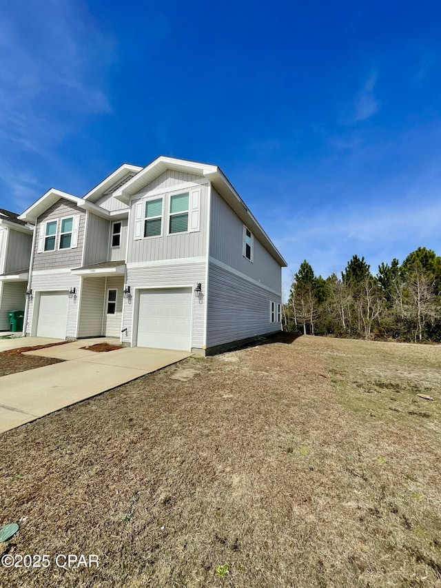 view of front of home with a garage and a front lawn