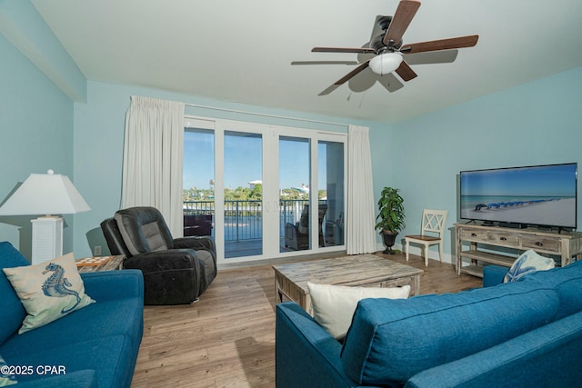 living room featuring ceiling fan and light hardwood / wood-style flooring