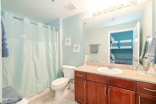 bathroom featuring tile patterned flooring, vanity, and toilet