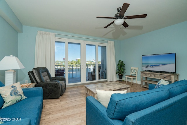 living room featuring ceiling fan and light hardwood / wood-style floors