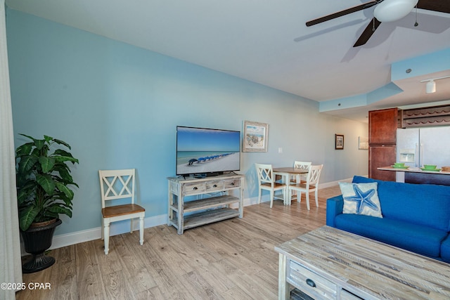 living room featuring ceiling fan and light hardwood / wood-style flooring