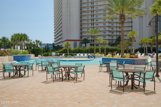 view of swimming pool with a patio and pool water feature