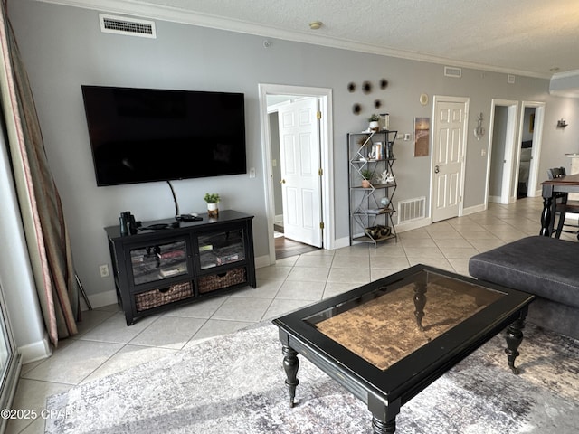 tiled living room with ornamental molding and a textured ceiling