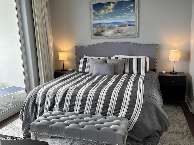 bedroom with dark wood-type flooring