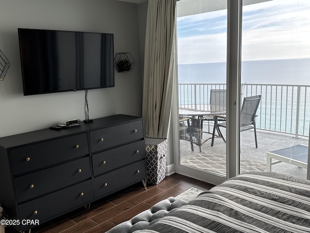 bedroom with a water view and access to exterior