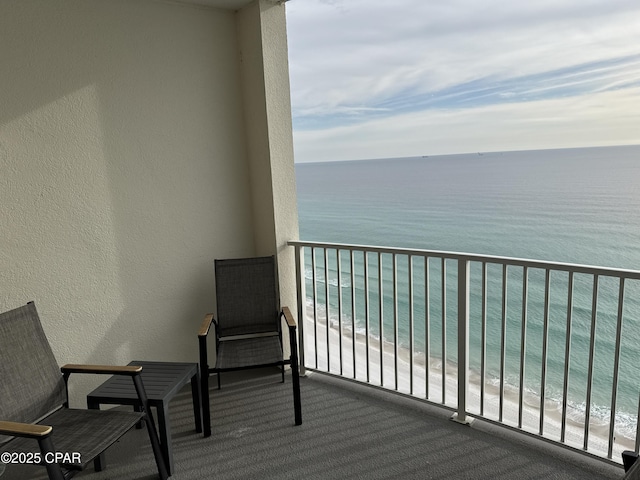 balcony with a view of the beach and a water view