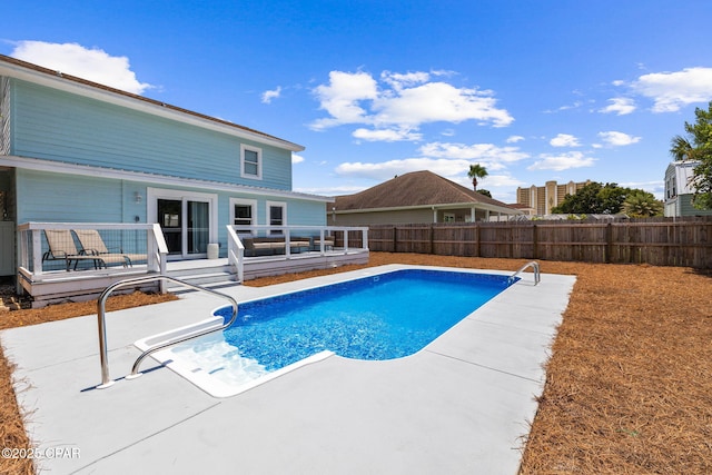 view of pool featuring a patio area and a deck