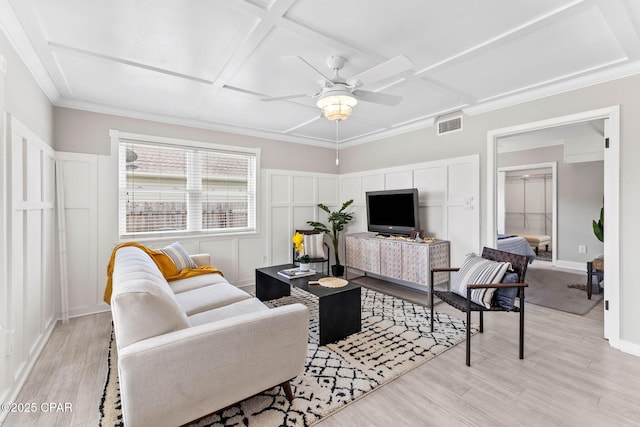 living room with coffered ceiling, ceiling fan, and light hardwood / wood-style flooring