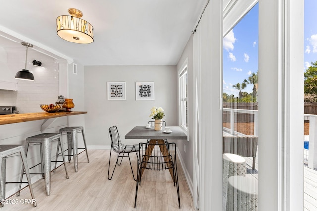 dining space with light wood-type flooring