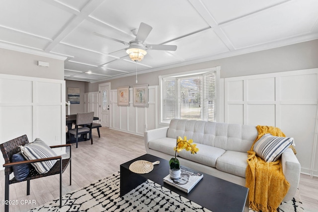 living room with ceiling fan, coffered ceiling, and light wood-type flooring