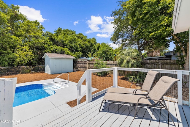 view of pool featuring a storage shed and a wooden deck